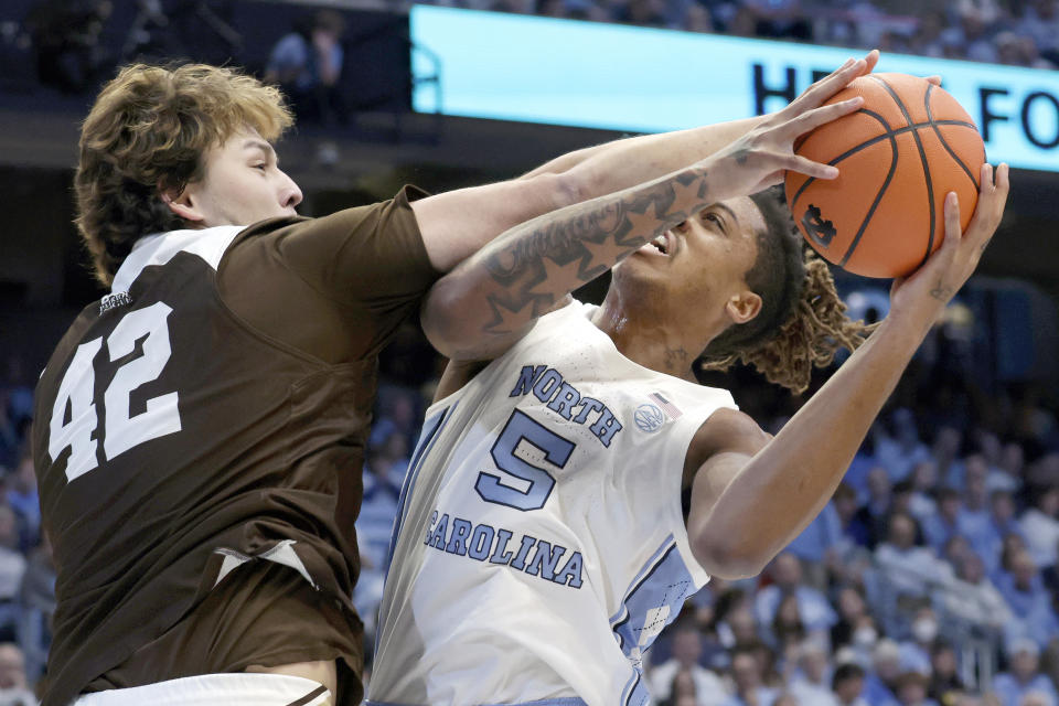 Lehigh center JT Tan (42) tries to block a shot by North Carolina forward Armando Bacot (5) during the first half of an NCAA college basketball game Sunday, Nov. 12, 2023, in Chapel Hill, N.C. (AP Photo/Chris Seward)