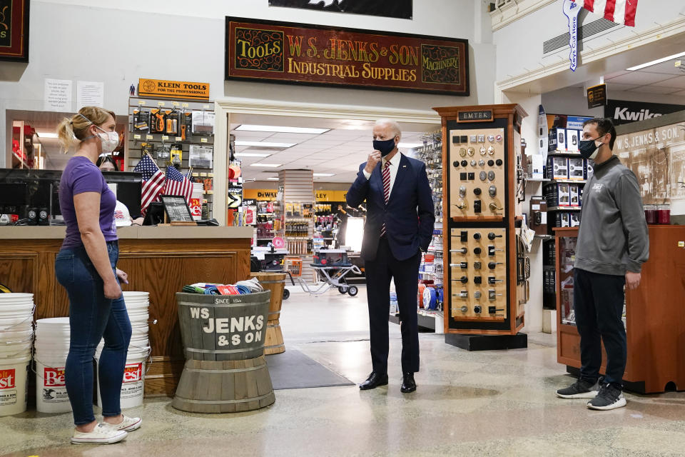 President Joe Biden speaks with Mary Anna Ackley, Owner of Little Wild Things Farm, left, and Michael Siegel, Co-owner of W.S. Jenks & Son, right, during a visit at W.S. Jenks & Son hardware store, a small business that received a Paycheck Protection Program loan, Tuesday, March 9, 2021, in Washington. (AP Photo/Patrick Semansky)