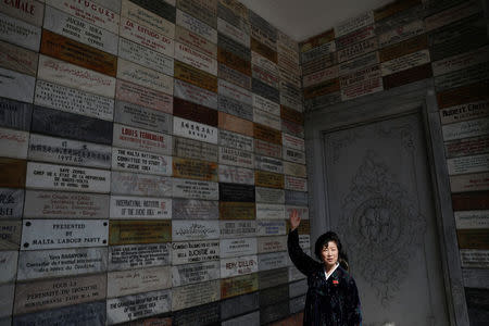 A guide talks to foreign reporters as they visit the 170-metre (558-feet) tall Juche Tower in central Pyongyang, North Korea April 12, 2017. REUTERS/Damir Sagolj