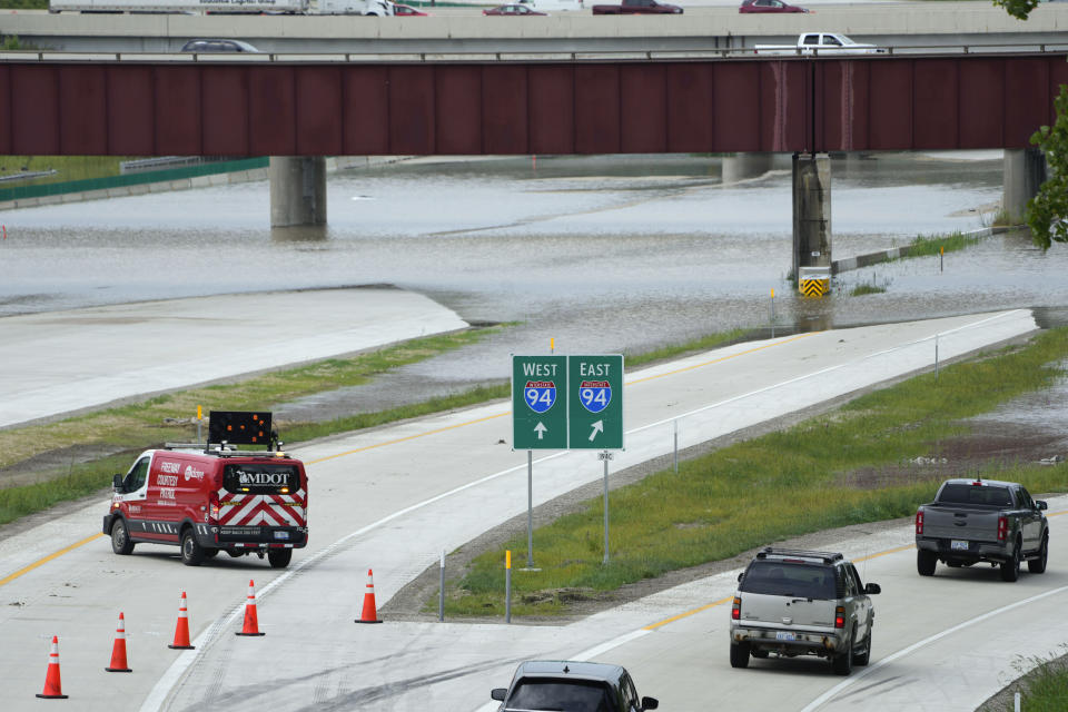 Traffic is redirected from I-275 after overnight flooding left vehicles stranded near the Detroit Metropolitan Airport in Romulus, Mich., Thursday, Aug. 24, 2023. (AP Photo/Paul Sancya)