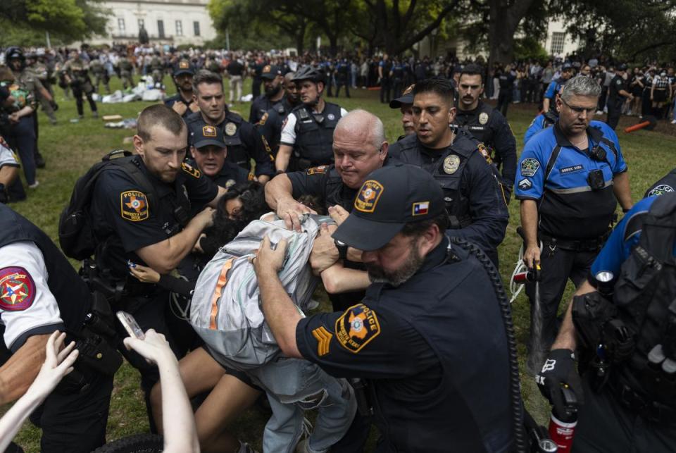 University of Texas police officers detain pro-Palestinian demonstrators during Wednesday's student walkout on campus. <cite>Credit: Julius Shieh for The Texas Tribune</cite>
