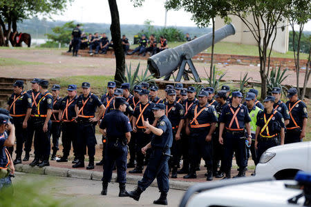 Police officers gather near the Congress building before a demonstration against a proposed amendment that would allow Paraguay's president to stand for re-election, in Asuncion, Paraguay April 4, 2017. REUTERS/Jorge Adorno