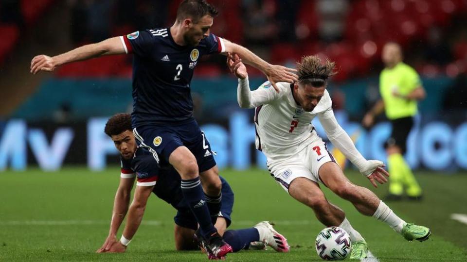 Scotland's Stephen O'Donnell challenges England's Jack Grealish