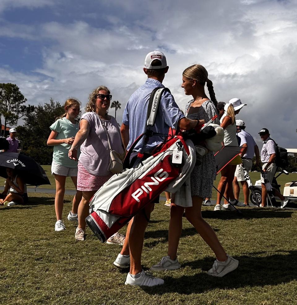 Hamilton Coleman of Augusta, Ga., turns to embrace his mother Sara (left) after being congratulated on winning the Junior Players Championship by his girlfriend Grace Mitchell (right). Behind his mother is his sister Caroline.