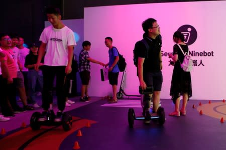 Man tries a Segway self-balancing scooter before a Segway-Ninebot product launch event in Beijing