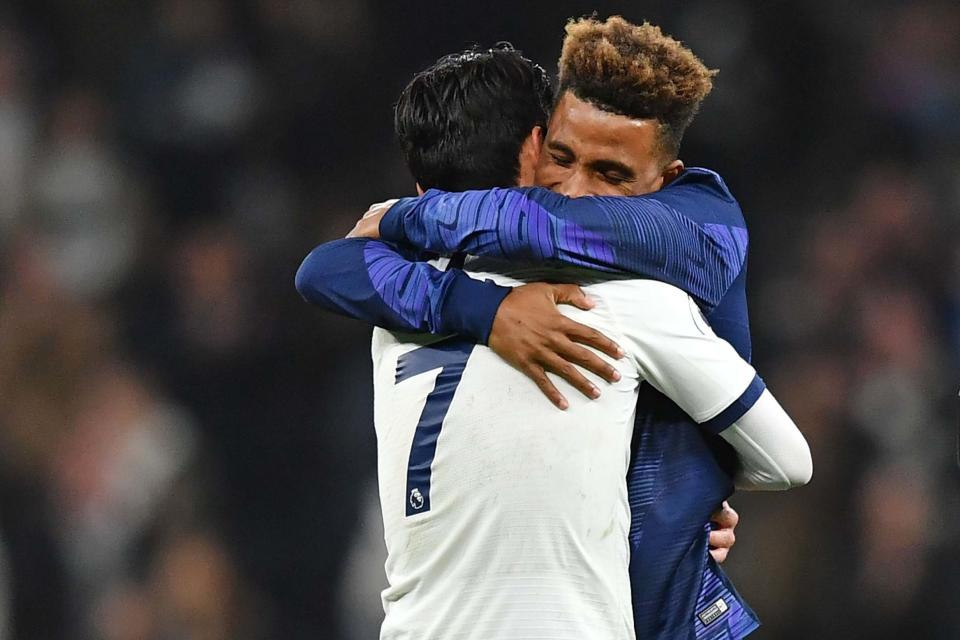 Tottenham Hotspur's Heung-Min Son, left, and Gedson Fernandes embrace on the pitch: AFP via Getty Images