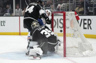 Los Angeles Kings goaltender Cam Talbot, center, is scored on by Edmonton Oilers left wing Zach Hyman, right, as defenseman Mikey Anderson defends during Game 3 of an NHL hockey Stanley Cup first-round playoff series Friday, April 26, 2024, in Los Angeles. (AP Photo/Mark J. Terrill)