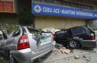 A view of vehicles that were damaged by falling debris after an earthquake struck Cebu city, central Philippines October 15, 2013. REUTERS/STRINGER