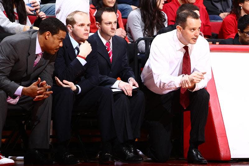 Brad Wachtel, second from right, seated next to former Rutgers head coach Mike Rice (far right) during an undated Rutgers basketball game