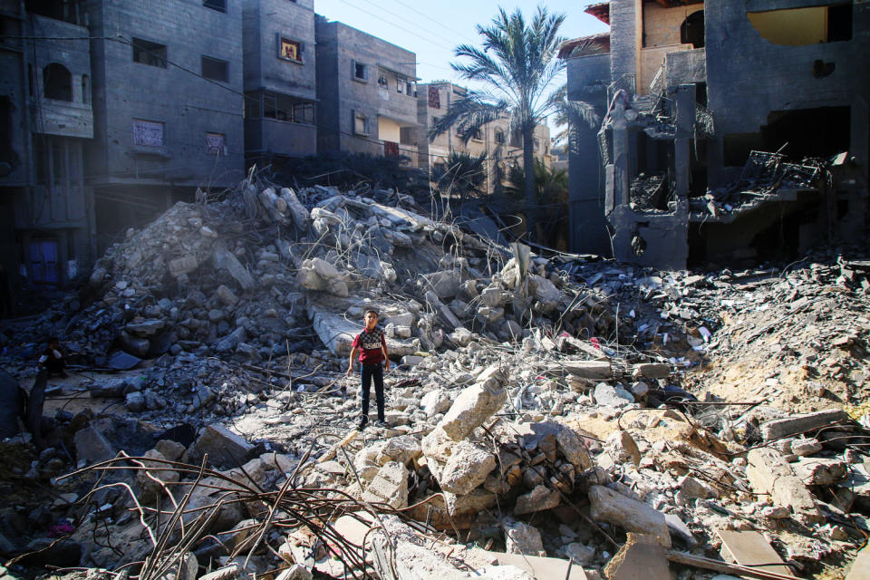 A boy stands in the rubble of a building destroyed by an Israeli airstrike in Khan Yunis in the southern Gaza Strip on Oct. 20, 2023. (Ahmad Hasaballah / Getty Images)