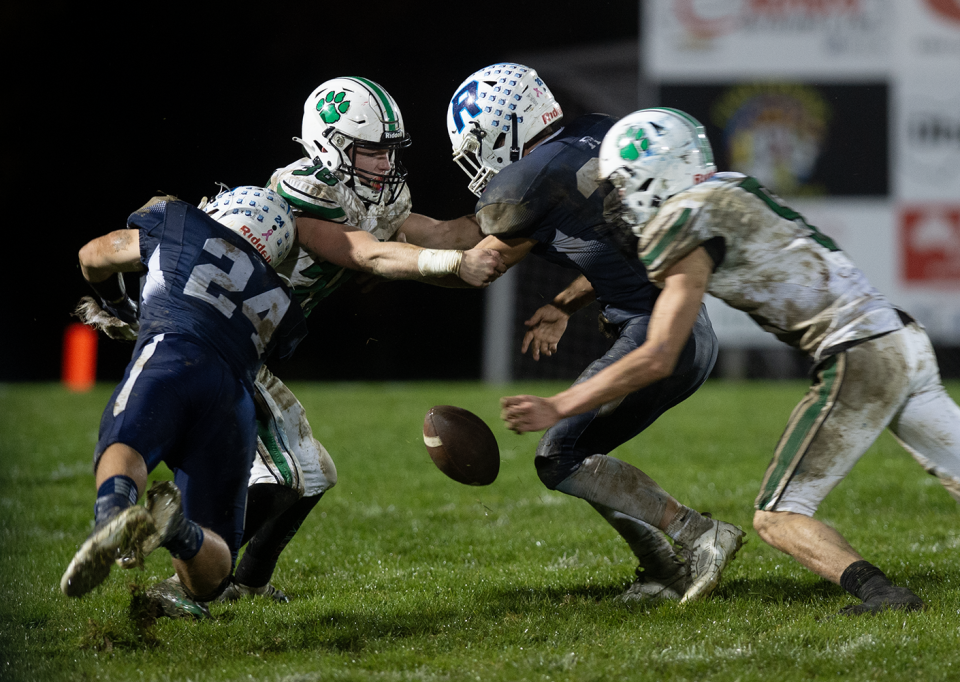 Mogadore's Chad Westfall and Will Baskey and Rootstown's Dawson Morgan and Dominic Duvall during a Rover fumble .