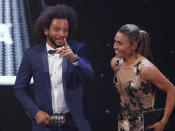 Brazil's soccer player Marta, right, talks to Brazil Marcelo, left, after she received the Best FIFA Women's player award during the ceremony of the Best FIFA Football Awards in the Royal Festival Hall in London, Britain, Monday, Sept. 24, 2018. (AP Photo/Frank Augstein)