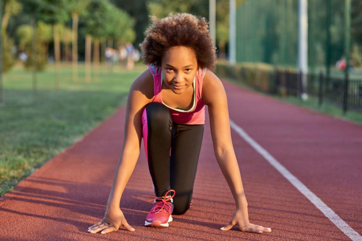 little girl standing in start position before the sprint