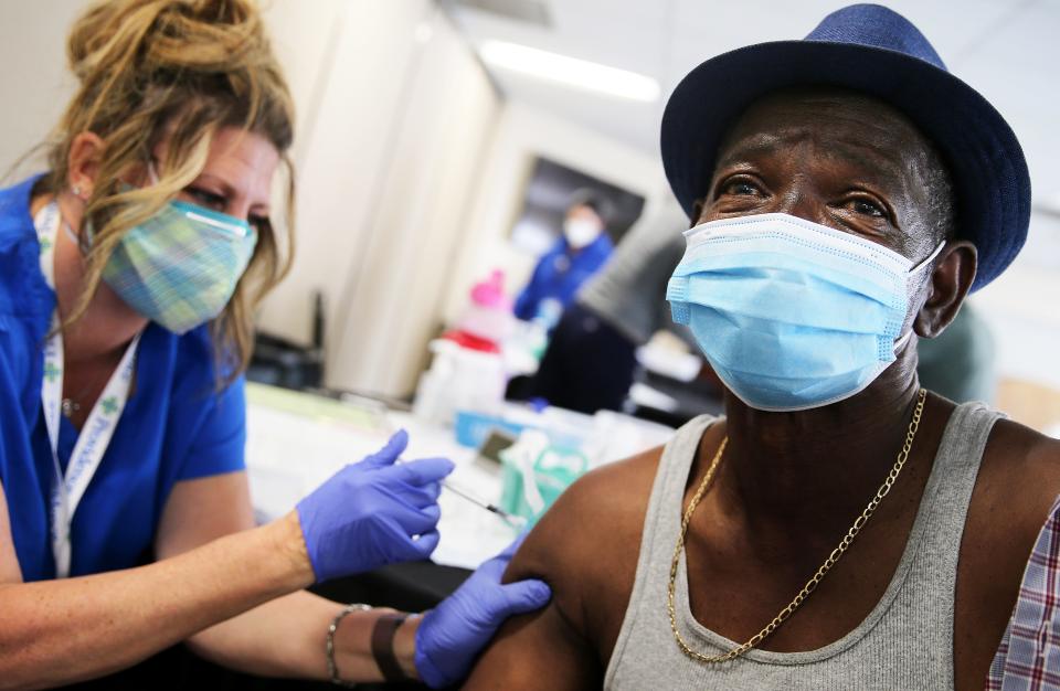 Larry Green (R) receives his second dose of the Moderna COVID-19 vaccine from registered nurse Teresa Frey at Lincoln Memorial Congregational Church UCC on March 12, 2021, in Los Angeles. The Providence health organization pop-up vaccine clinic was held at the predominantly Black church as part of their health equity campaign in communities of color.