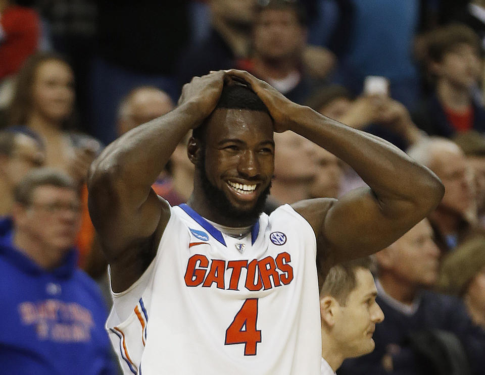 Florida center Patric Young (4) celebrates after the second half in a regional final game against Dayton at the NCAA college basketball tournament, Saturday, March 29, 2014, in Memphis, Tenn. Florida won 62-52. (AP Photo/John Bazemore)