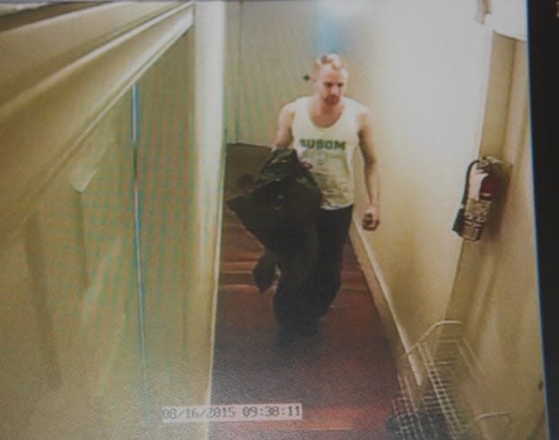 This still from surveillance video shows William Sandeson in the hallway outside of his apartment. (Nova Scotia Supreme Court - image credit)