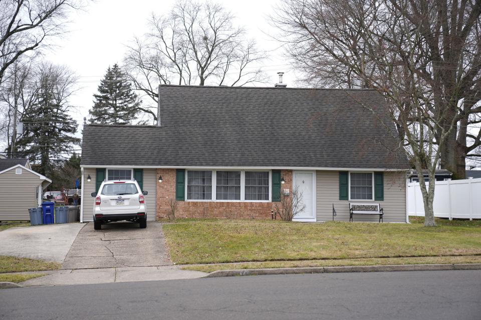 A vehicle is parked in the driveway of a home that was a scene of a murder in Levittown, Pa., on Wednesday, Jan. 31, 2024. A man has been charged with first-degree murder and abusing a corpse after his father was found decapitated. Police are investigating a video on social media that allegedly shows him holding up the head. The father was found beheaded in the bathroom of his home in Levittown, on Tuesday night.