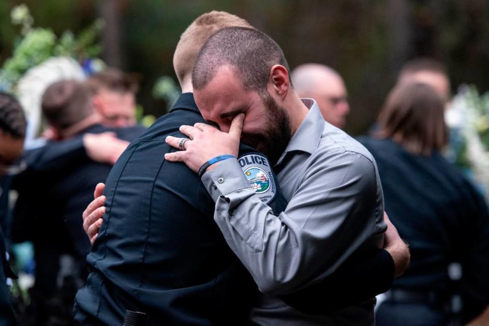 Bay St. Louis police officers react as Capt. Rachel Jewell calls in the last radio call at the gravesite of Bay St. Louis police officers Sgt. Steven Robin and Branden Estorffe at Gardens of Memory cemetery in Bay St. Louis on Wednesday, Dec. 21, 2022. Robin and Estorffe were killed responding to a call at a Motel 6 on Dec. 14.