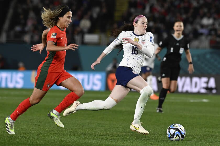 United States' Rose Lavelle runs clear of Portugal's Dolores Silva, left, during the Women's World Cup.