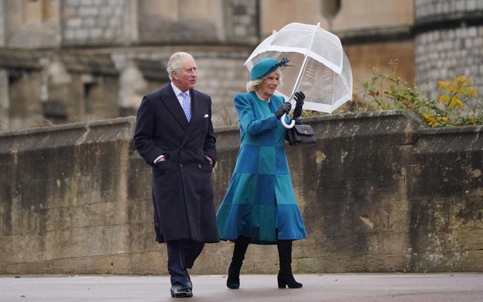 The Prince of Wales and the Duchess of Cornwall arrive to attend the Christmas Day morning church service at St George's Chapel - PA