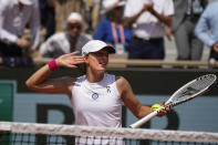 Poland's Iga Swiatek celebrates winning her quarterfinal match of the French Open tennis tournament against Coco Gauff of the U.S. in two sets 6-4, 6-2, at the Roland Garros stadium in Paris, Wednesday, June 7, 2023. (AP Photo/Christophe Ena)