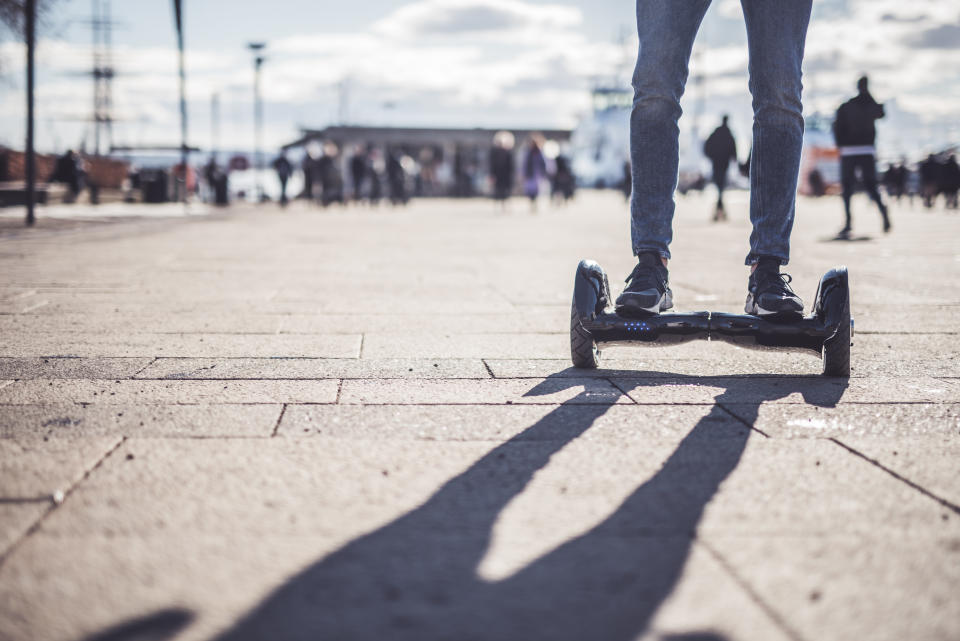 Close up of man riding a hoverboard.