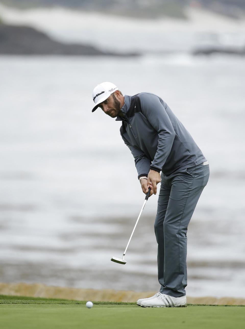 Dustin Johnson putts on the 18th green of the Pebble Beach Golf Links during the final round of the AT&T Pebble Beach Pro-Am golf tournament Sunday, Feb. 9, 2014, in Pebble Beach, Calif. Johnson finished tied for second place after shooting a 6-under-par 66 to finish at total 10-under-par. (AP Photo/Eric Risberg)