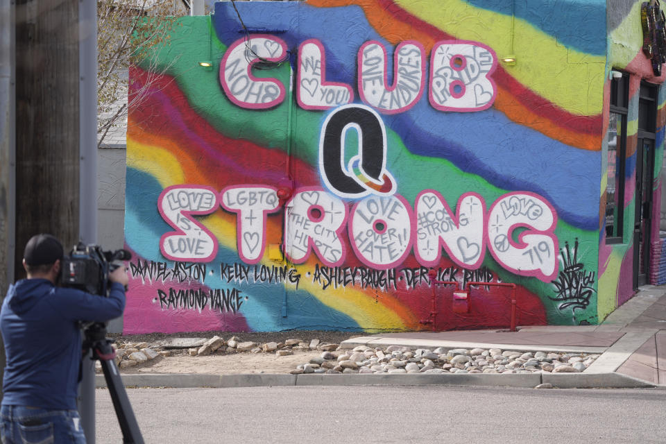 FILE - A television cameraman works near a tribute to the victims of a mass shooting at a gay nightclub painted on the side of a downtown commercial building Nov. 23, 2022, in Colorado Springs, Colo. A hearing is scheduled to start Wednesday, Feb. 22, for Anderson Lee Aldrich in the shooting. (AP Photo/David Zalubowski, File)