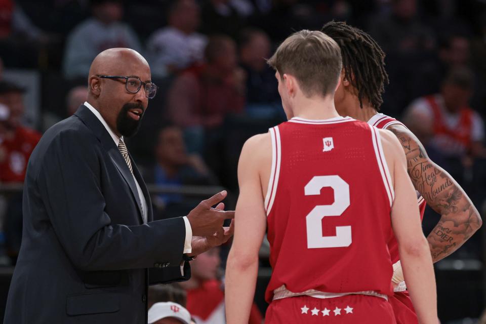 Nov 20, 2023; New York, NY, USA; Indiana Hoosiers head coach Mike Woodson talks with guard Gabe Cupps (2) and guard CJ Gunn (11) during the first half against the Louisville Cardinals at Madison Square Garden.