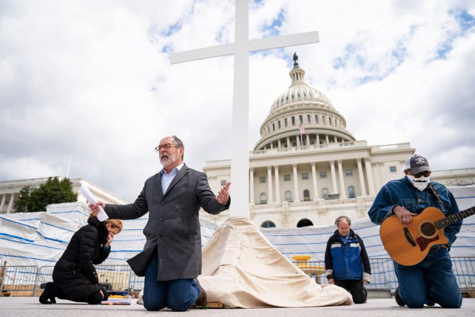 <div class="inline-image__caption"><p>Rev. Patrick Mahoney, director of the Christian Defense Coalition, kneels in prayer as he livestreams a Good Friday service on the grounds of the U.S. Capitol on April 10, 2020 in Washington, D.C. Amidst the COVID-19 pandemic, Christians around the globe will mark the Easter holiday on Sunday, April 12. </p></div> <div class="inline-image__credit">Drew Angerer/Getty Images</div>
