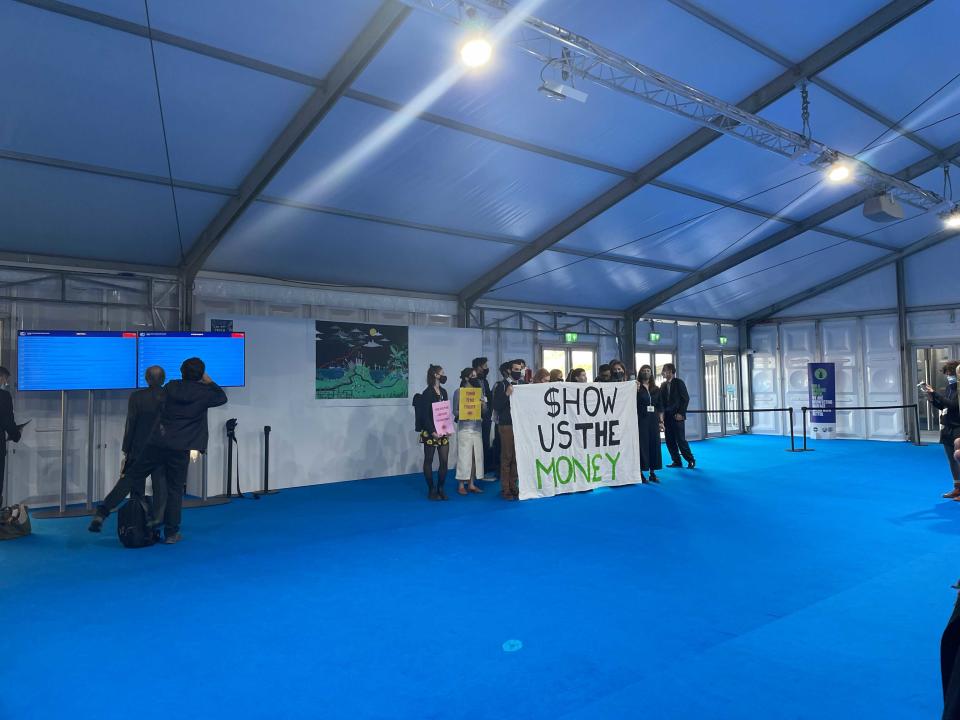 A small group of protesters near the entrance to the conference centre (The Independent)