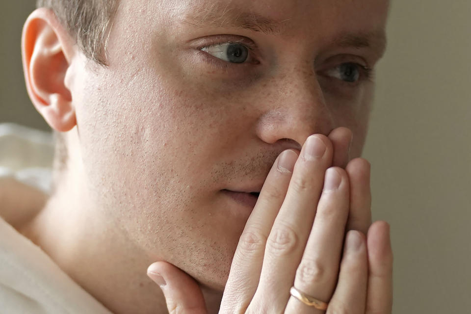 Ukrainian Dmytro Remez pauses during an interview with the Associated Press at his dormitory room in Tokyo, on Feb. 15, 2023. Remez, 24, a fledgling medical doctor studying at Juntendo University, is among the 2,291 Ukrainians who have moved to Japan since the war with Russia began a year ago. (AP Photo/Shuji Kajiyama)