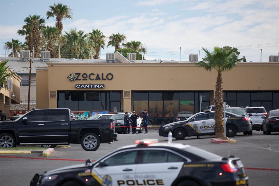 El Paso investigate the scene of a mass shooting that killed two people and wounded four others on July 13 in the parking lot of Airway Plaza, 1160 Airway Blvd., an area of bars and restaurants, in East-Central El Paso.