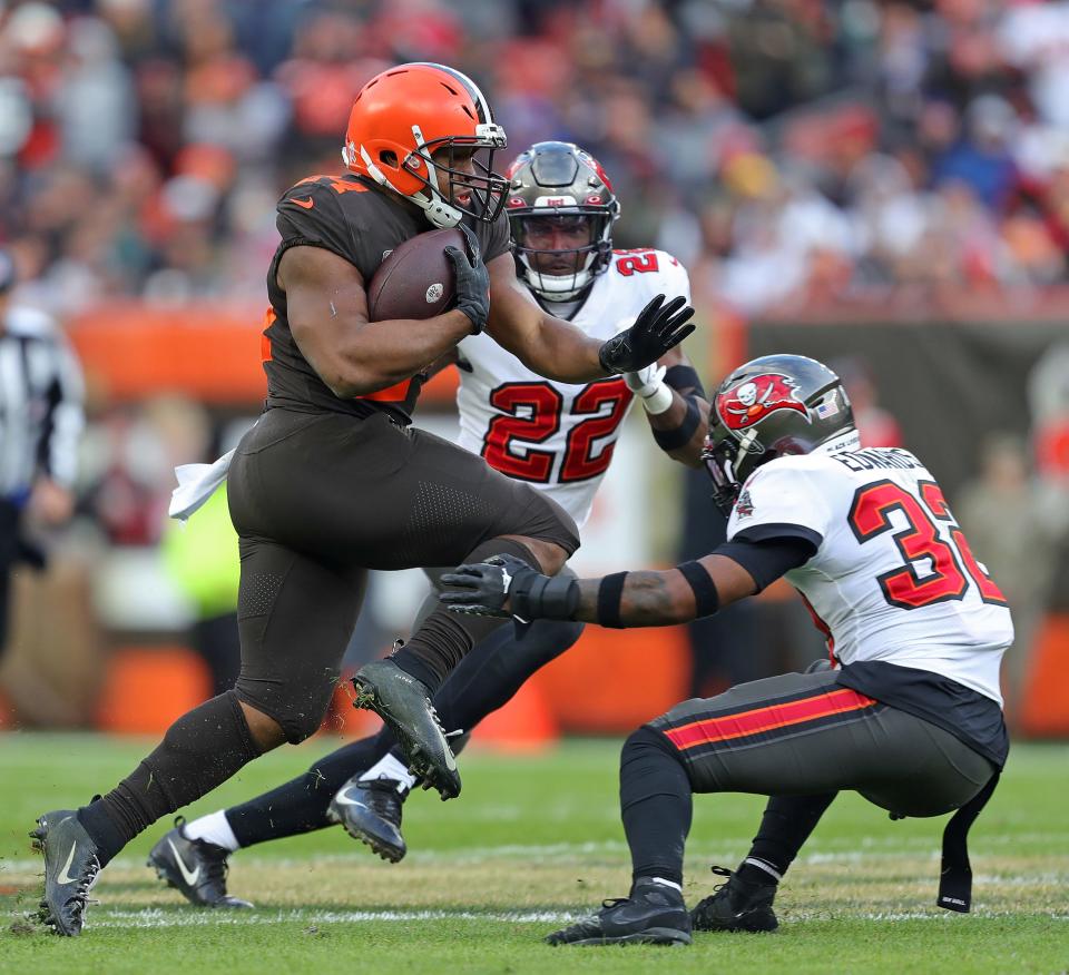 Cleveland Browns running back Nick Chubb (24) runs for yards against Tampa Bay Buccaneers safety Mike Edwards (32) during the second half of an NFL football game at FirstEnergy Stadium, Sunday, Nov. 27, 2022, in Cleveland, Ohio.