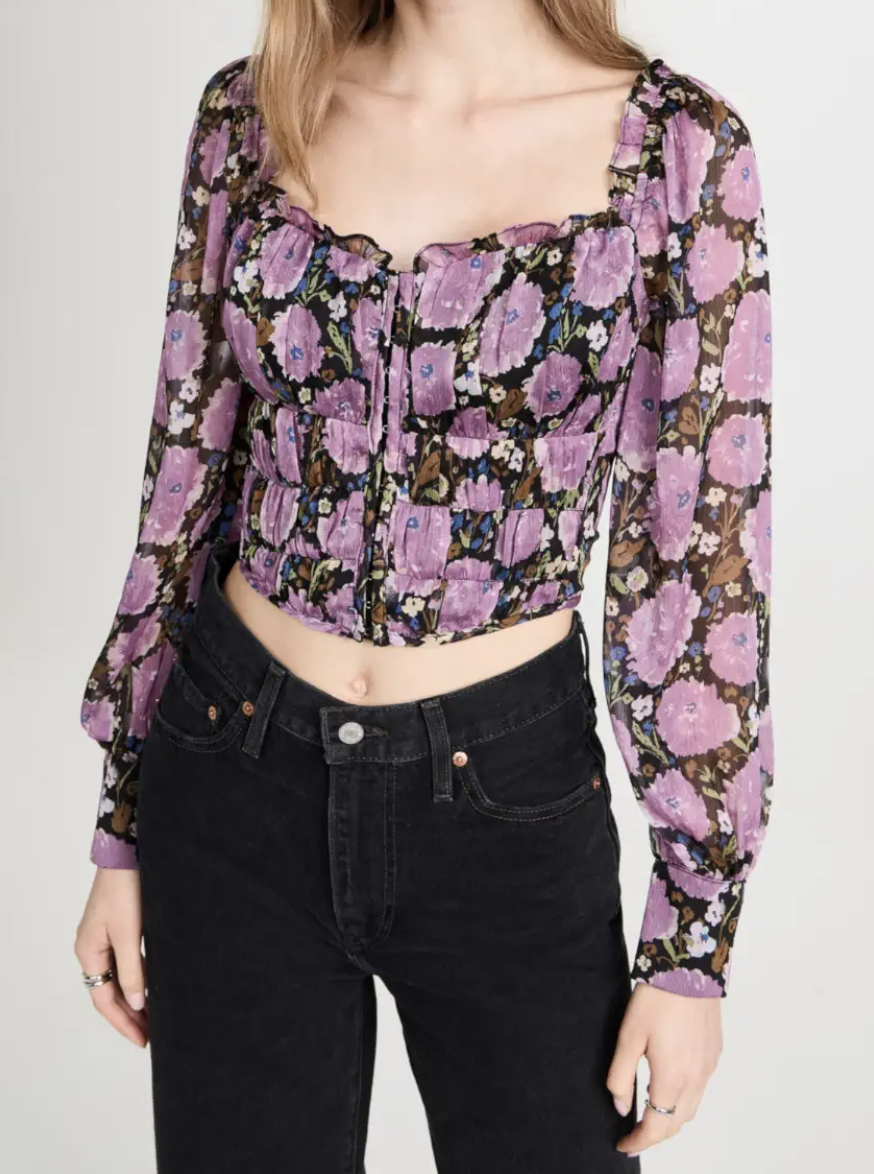 model wearing purple floral blouse