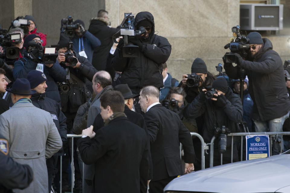 Harvey Weinstein, center, walks by the media on his way into a Manhattan courthouse for his trial on rape and sexual assault charges, Wednesday, Jan. 22, 2020, in New York. (AP Photo/Mark Lennihan)
