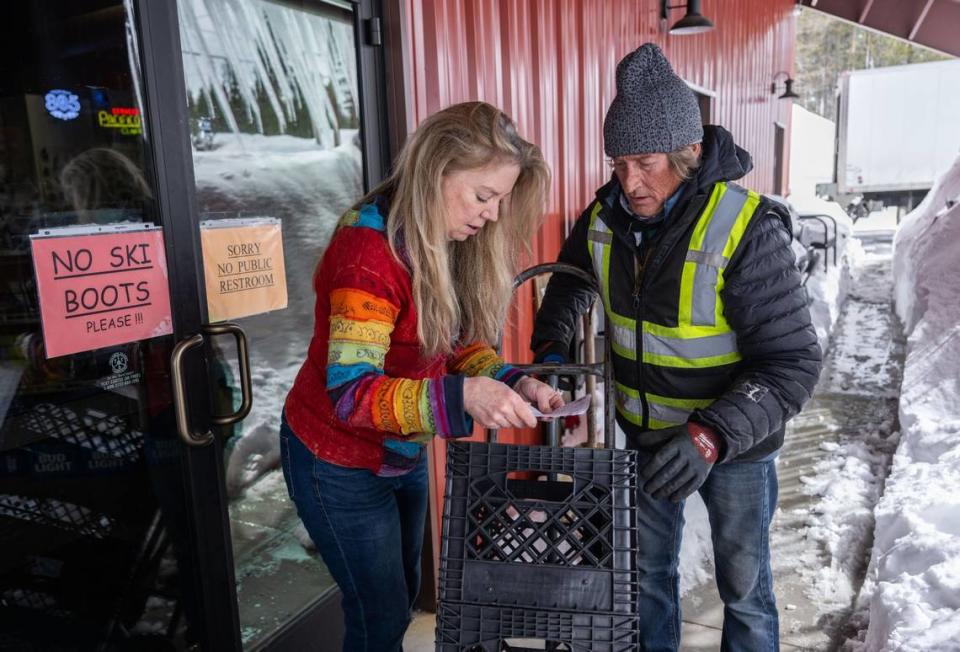 Cheryl Paduano, owner of Soda Springs Store, reviews an order with Ben Holder after he made a delivery earlier this month. Paduano said she never closed her store during the recent blizzard because she knew customers would be needing supplies. Hector Amezcua/hamezcua@sacbee.com