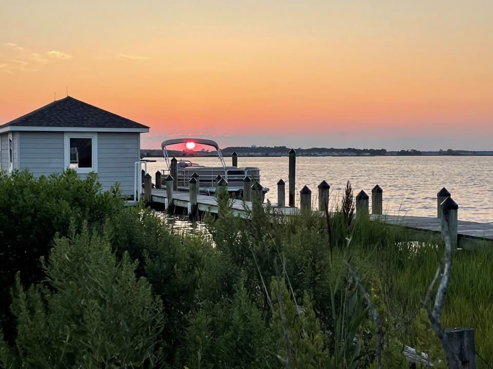 An early August sun sets on the bay in Dewey Beach.