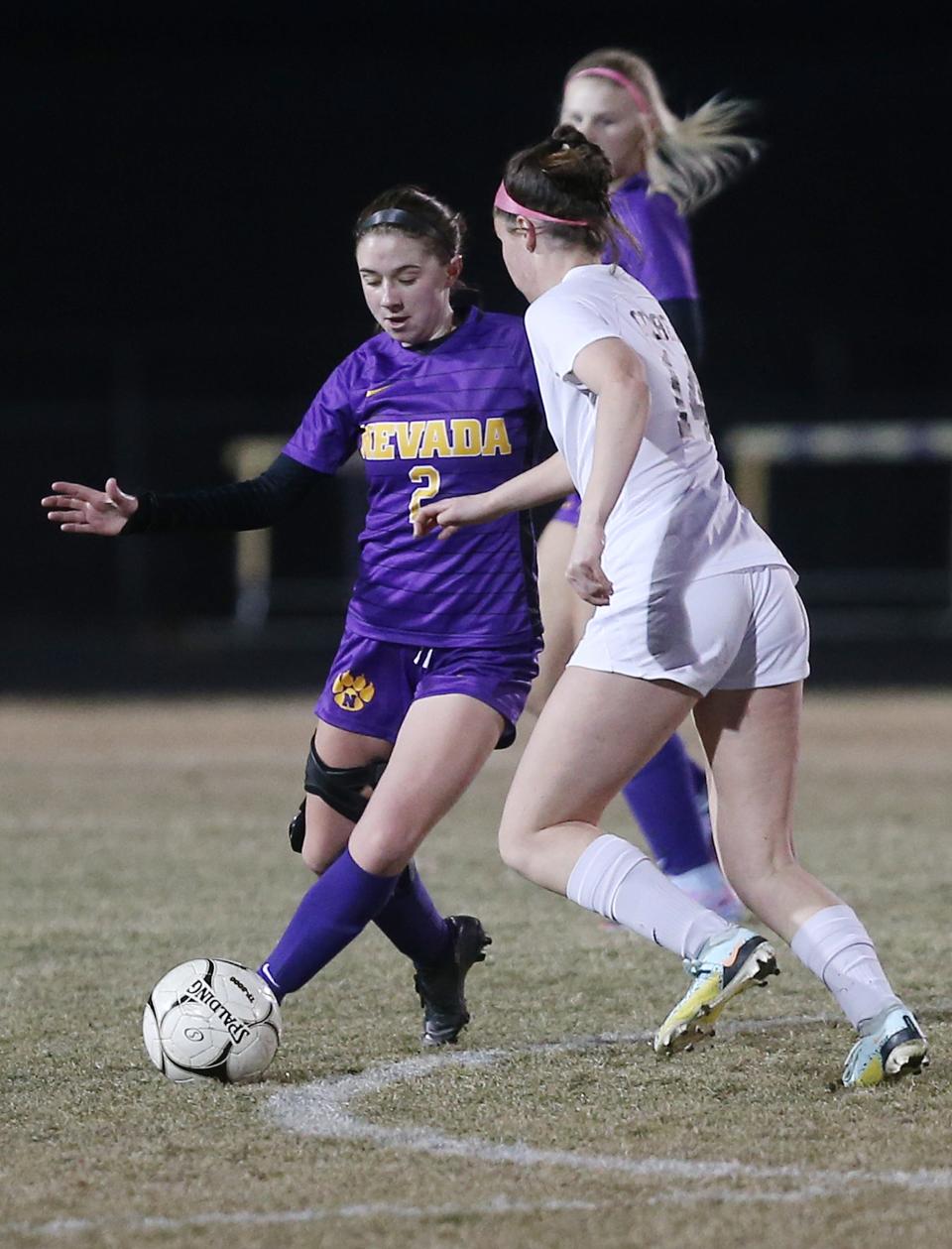 Nevada midfielder Tori Meinecke (2) clears the ball away from Gilbert's Sarah Thatcher (14) during the second half of the Cubs' 3-2 shootout victory at Cub Stadium on Monday, March 27, 2023, in Nevada, Iowa.