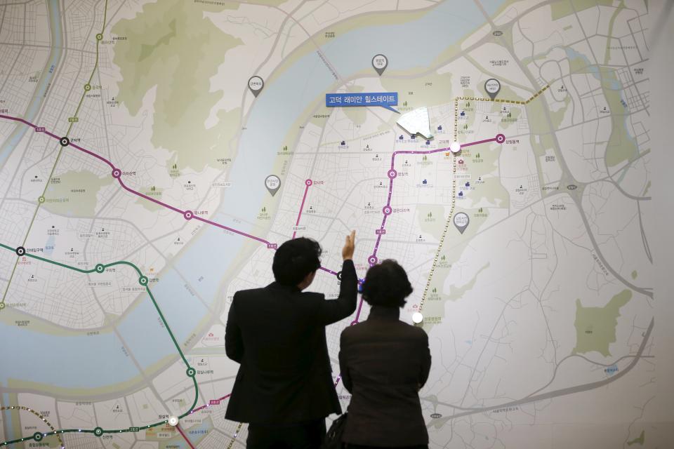 A salesperson talks with a visitor in Seoul - REUTERS/Kim Hong-Ji