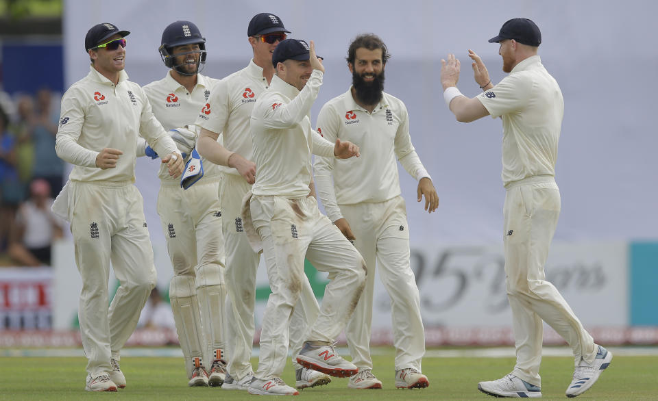 England's Moeen Ali, second right, celebrates the dismissal of Sri Lanka's Niroshan Dickwella with team mates during the fourth day of the first test cricket match between Sri Lanka and England in Galle, Sri Lanka, Friday, Nov. 9, 2018. (AP Photo/Eranga Jayawardena)