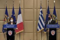 French Defense Minister Florence Parly, left, and his Greek counterpart Nikos Panagiotopoulos make statements after signing the Rafale warplane deal in Athens, Monday, Jan. 25, 2021. Greece is due to sign a 2.3 billion euro ($2.8 billion) deal with France Monday to purchase 18 Rafale fighter jets to address tension with neighbor Turkey. (Louisa Gouliamaki/Pool via AP)