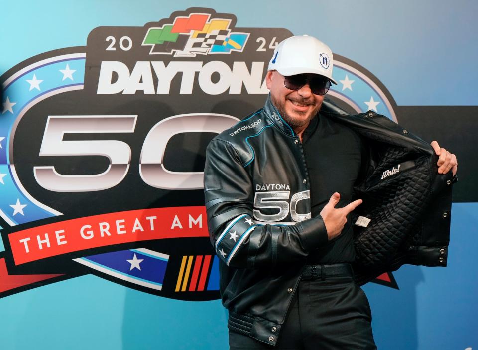 Pitbull models his new Daytona 500 jacket during a press conference in at Daytona International Speedway, Sunday, Feb. 18, 2024.