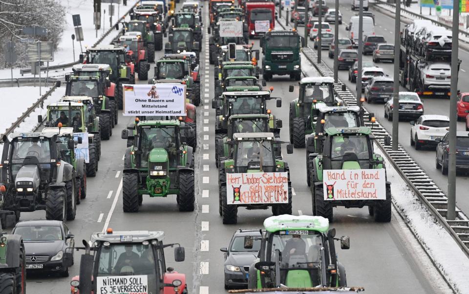 Farmers cause traffic chaos as they protest by driving their tractors on the Mittlerer Ring road around Munich