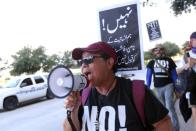 A counter-demonstrator protests during a "Howdy, Modi" rally celebrating India's Prime Minister Narenda Modi at NRG Stadium in Houston