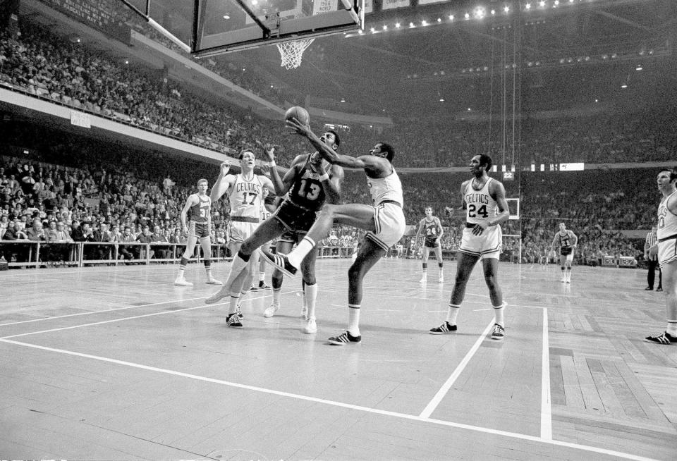 Boston Celtics’ Bill Russell snares rebound from outstretched hands of Los Angeles Lakers’ Wilt Chamberlain, in the second period of their NBA playoff game at Boston Garden, April 30, 1969. Watching is Celtics’ John Havlicek. Boston won 89-88 to even the series at two games apiece. (AP Photo/Bill Chaplis)