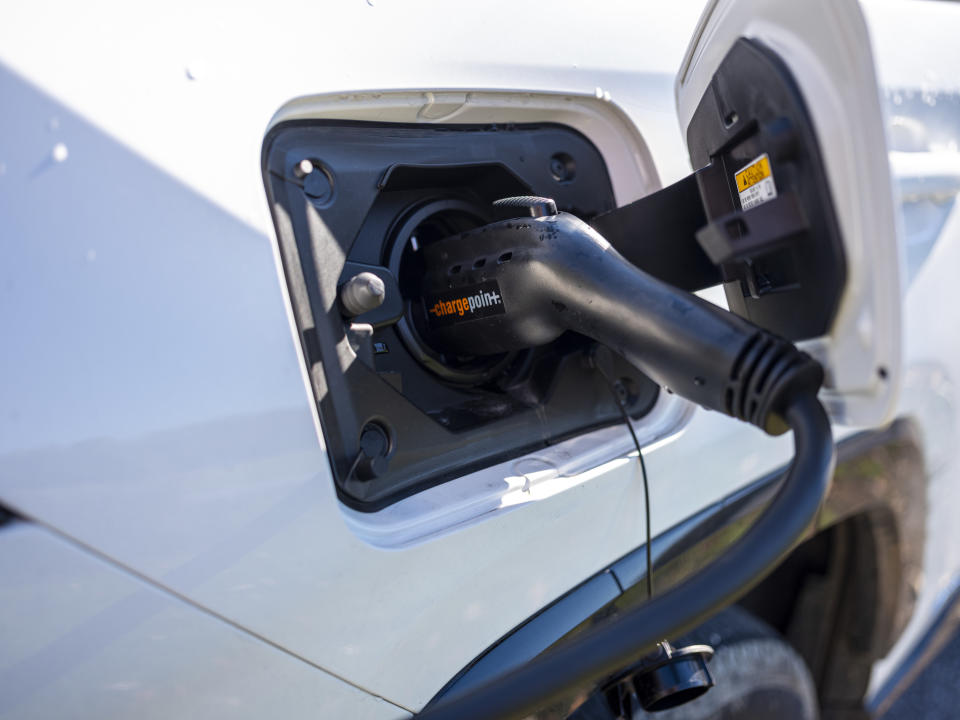 CHARLOTTE, VERMONT - NOVEMBER 5: A 2021 Toyota RAV4 Prime electric car recharges its batteries November 5, 2021 at a charging station next to the town hall in Charlotte, Vermont. The starting price for a RAV4 Prime plug-in hybrid is $38,350. The electric charging hookup is made by ChargePoint, a California electric vehicle infrastructure company. (Photo by Robert Nickelsberg/Getty Images)