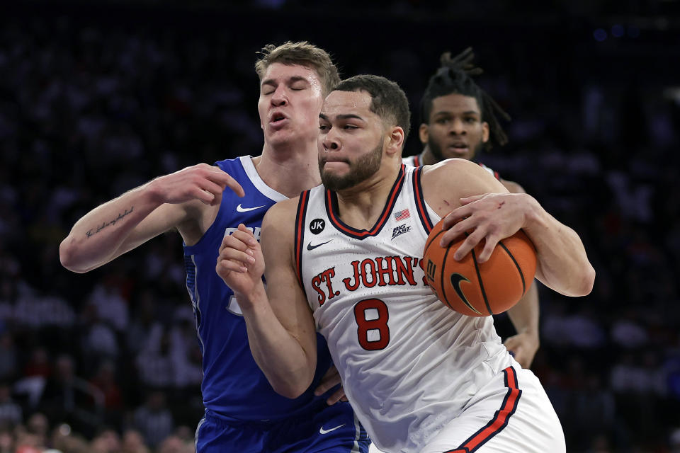 FILE -St. John's guard Chris Ledlum (8) drives to the basket past Creighton guard Baylor Scheierman during the second half of an NCAA college basketball game, Sunday, Feb. 25, 2024, in New York. St. John's basketball players Chris Ledlum and Jordan Dingle have filed a lawsuit against the NCAA for denying their request for an eligibility waiver that would give them one more season of competition with the Red Storm or another team.(AP Photo/Adam Hunger, File)