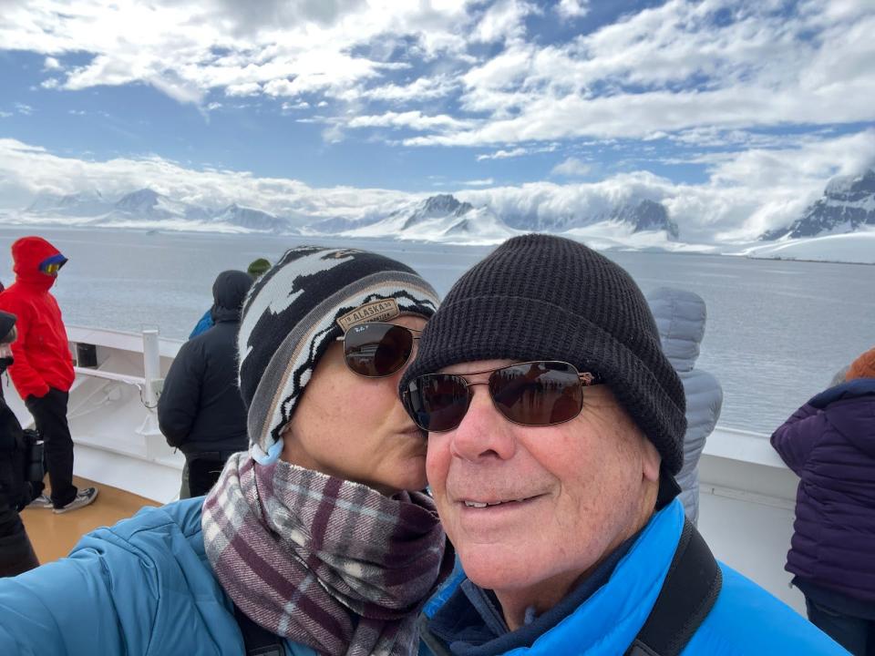 Rebecca Reuter kissing her husband's cheek while bundled up