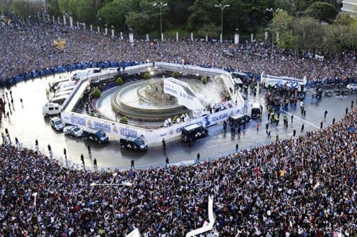 Real Madrid's players arrive on an open bus at Cibeles square in Madrid. Thousands of jubilant Real Madrid fans swamped the centre of the Spanish capital on Thursday to see their heroes parade in an open-top bus in celebration of their league title success